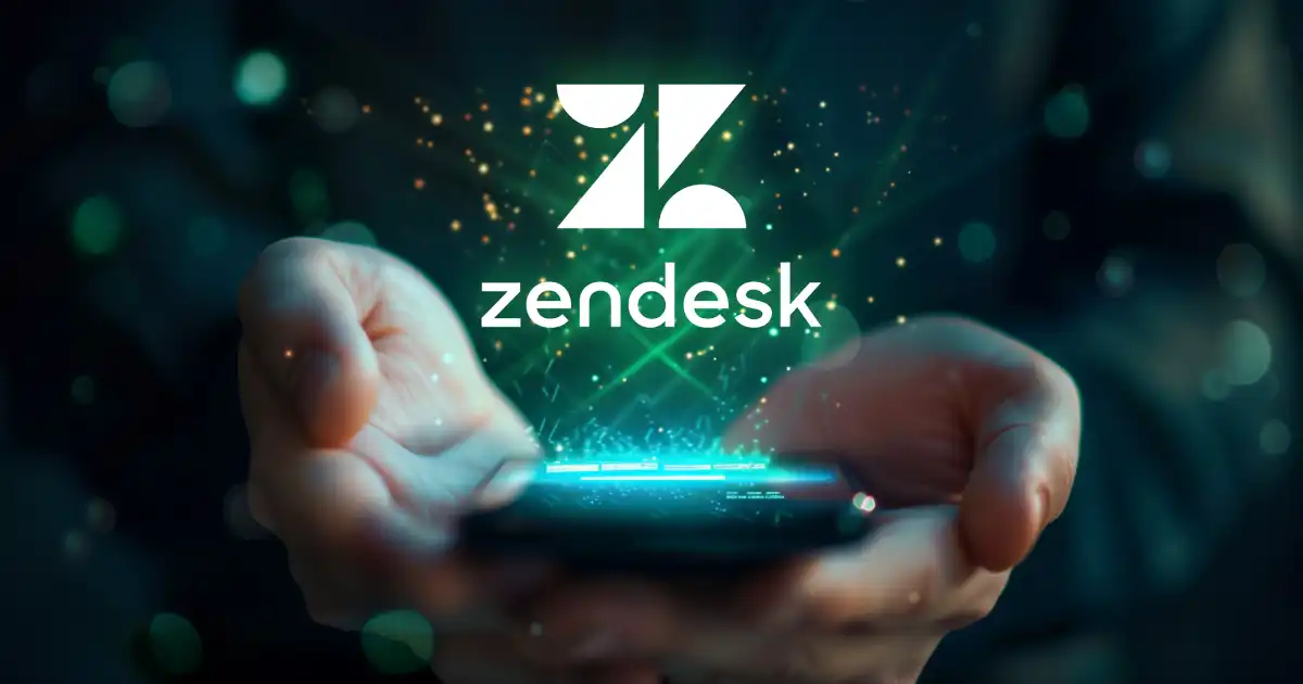 A pair of hands holding a smartphone with the Zendesk logo glowing above the screen