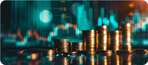 Stacks of coins in front of a blurred financial chart