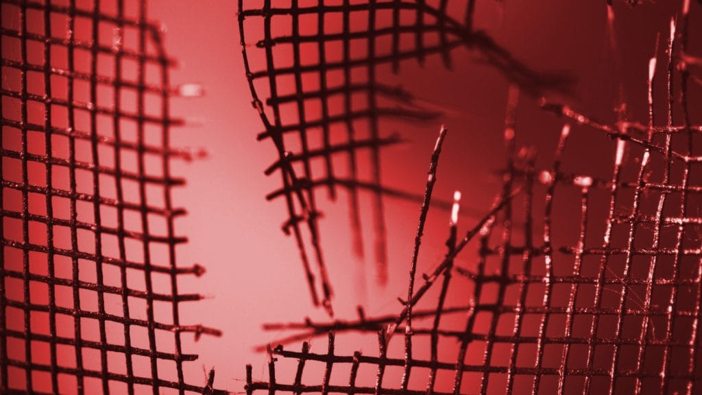 A Close Up Of A Broken Mesh Fence