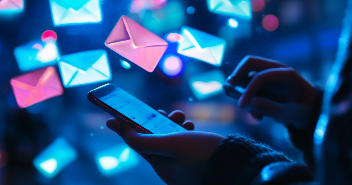 User holding an iPhone and browsing incoming emails